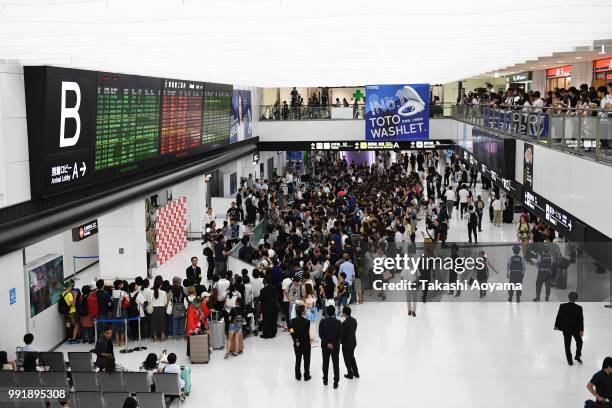 Fans and press wait for the Japan national team in the arrivals hall at Narita International Airport on July 5, 2018 in Narita, Narita, Japan.