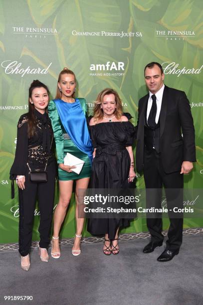 Guest, model Petra Nemcova, Caroline Scheufele and Milutin Gatsby attend the amfAR Paris Dinner 2018 at The Peninsula Hotel on July 4, 2018 in Paris,...