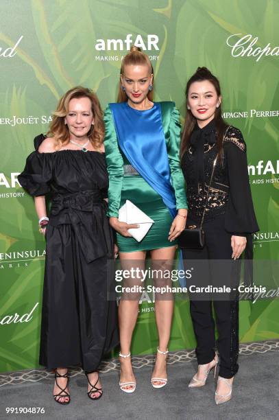 Caroline Scheufele, model Petra Nemcova and a guest attend the amfAR Paris Dinner 2018 at The Peninsula Hotel on July 4, 2018 in Paris, France.