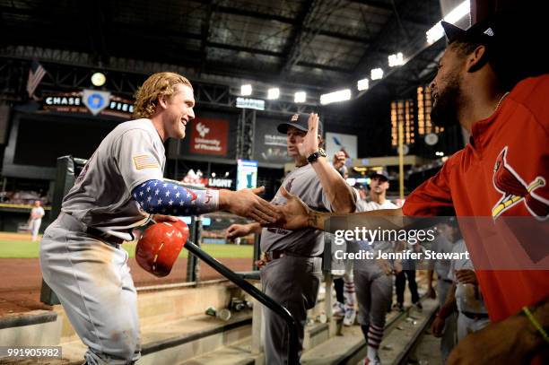 Harrison Bader of the St. Louis Cardinals celebrates in the dugout after scoring against the Arizona Diamondbacks in the eighth inning of the MLB...