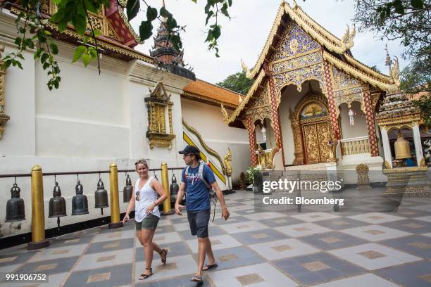 Tourists walks through Wat Phra That Doi Suthep in Chiang Mai, Thailand, on Wednesday, July 4, 2018. Thai inflation unexpectedly eased a bit in June...