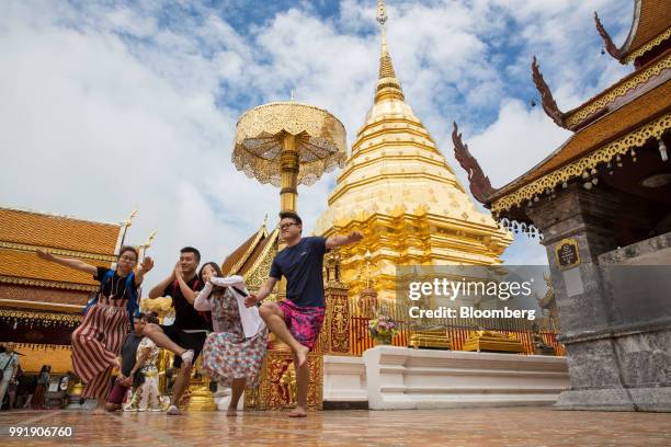 Tourists pose for a photographs at Wat Phra That Doi Suthep in Chiang Mai, Thailand, on Wednesday, July 4, 2018. Thai inflation unexpectedly eased a...
