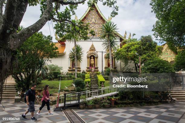 Tourists walks through Wat Phra That Doi Suthep in Chiang Mai, Thailand, on Wednesday, July 4, 2018. Thai inflation unexpectedly eased a bit in June...