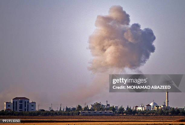 Smoke rises above rebel-held areas of the city of Saida, some 10 kilometers east of Daraa, during reported airstrikes by Syrian regime forces on July...