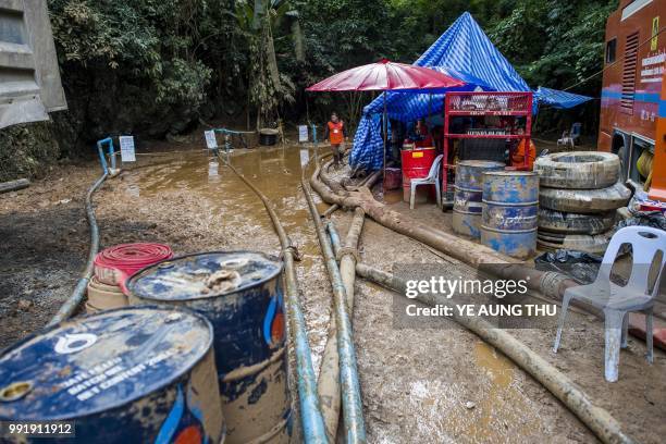 In this picture taken on July 4 Thai rescue personnel pump water from Tham Luang cave during rescue operations for the trapped 12 boys and their...
