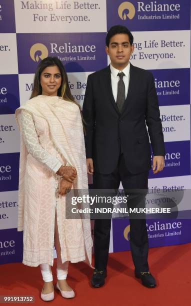 India's richest man and oil-to-telecom conglomerate Reliance Industries chairman Mukesh Ambani's children Isha and Akash arrive for the company's...