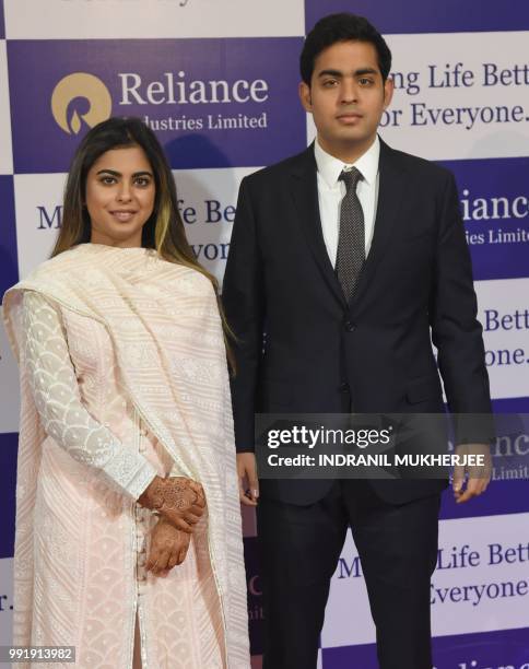 India's richest man and oil-to-telecom conglomerate Reliance Industries chairman Mukesh Ambani's children Isha and Akash arrive for the company's...