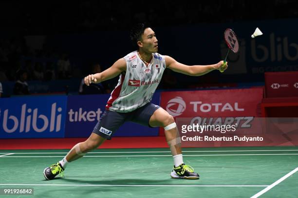 Kento Momota of Japan competes against Anthony Sinisuka Ginting of Indonesia during the Men's Singles Round 2 match on day three of the Blibli...