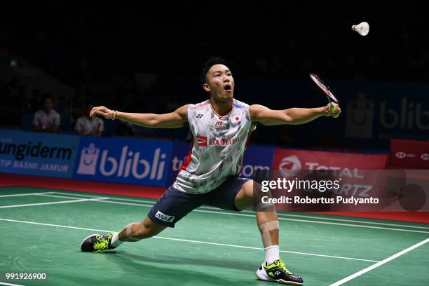 Kento Momota of Japan competes against Anthony Sinisuka Ginting of Indonesia during the Men's Singles Round 2 match on day three of the Blibli...