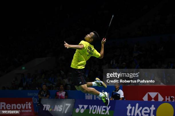 Anthony Sinisuka Ginting of Indonesia competes against Kento Momota of Japan during the Men's Singles Round 2 match on day three of the Blibli...