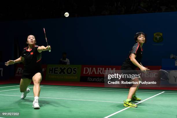 Chen Qingchen and Jia Yifan of China compete against Chow Mei Kuan and Lee Meng Yean of Malaysia during the Women's Doubles Round 2 match on day...