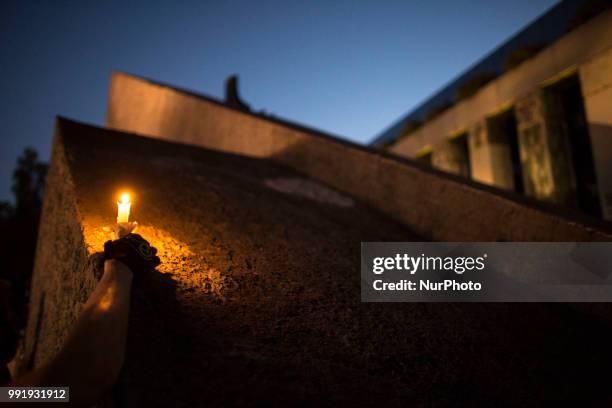 Protester holds a candle on background of Supreme Court during Protest Against Supreme Court Reforms in Warsaw on July 4, 2018.