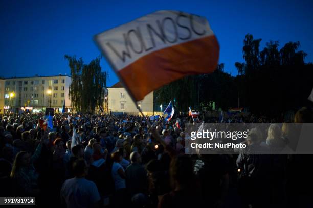Protester waves Polish flag with &quot;Freedom&quot; inscription during Protest Against Supreme Court Reforms in Warsaw on July 4, 2018.