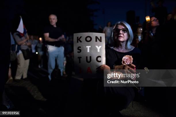 Protester holds a &quot;Constitution&quot; banner during Protest Against Supreme Court Reforms in Warsaw on July 4, 2018.