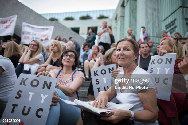 Protester holds a &quot;Constitution&quot; banner during Protest Against Supreme Court Reforms in Warsaw on July 4, 2018.