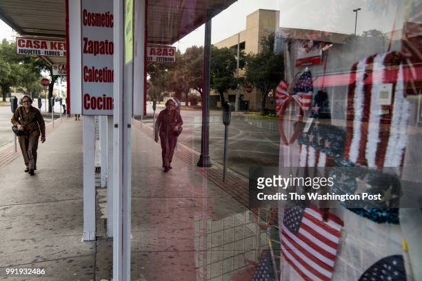 American flags hang in a shop window in downtown McAllen, Texas on July 3, 2018.
