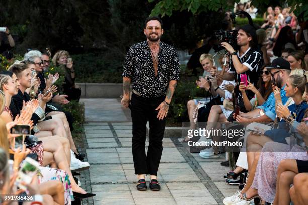 Fashion Designer Marcel Ostertag acknowledges the applause of the guests at the end of his fashion show during the Mercedes Benz Berlin Fashion Week...