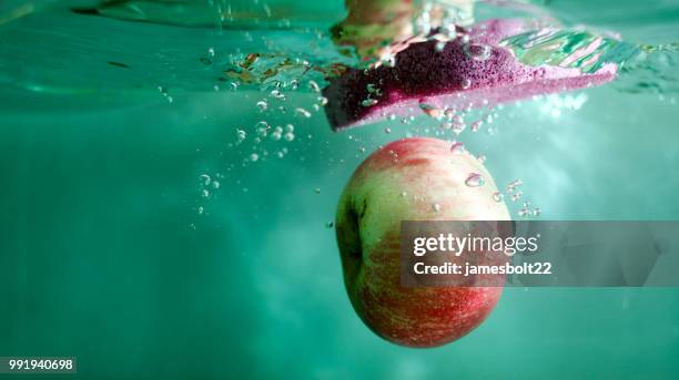 apple and sponge - splash crown stock pictures, royalty-free photos & images