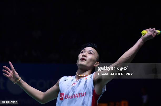 Kento Momota of Japan plays a return against Anthony Sinisuka Ginting of Indonesia during the men's singles badminton match at the Indonesia Open in...