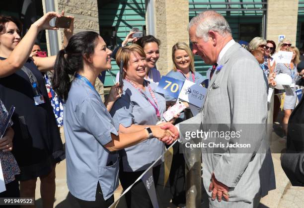 Prince Charles, Prince of Wales is greeted by hospital staff as he visits Ysbyty Aneurin Bevan to celebrate the 70th Anniversary of the NHS on July...