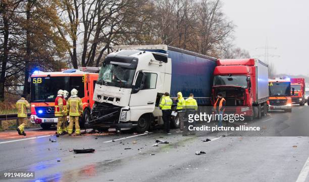 Firefighters and police officers stand on the motorway A2 after an accident at the motorway junction Hanover Buchholz, Germany, 21 November 2017....