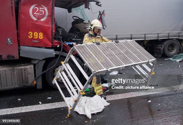 Firefighter stands on the motorway A2 after an accident at the motorway junction Hanover Buchholz, Germany, 21 November 2017. During an accident with...