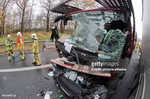 Firefighters stand on the motorway A2 after an accident at the motorway junction Hanover Buchholz, Germany, 21 November 2017. During an accident with...