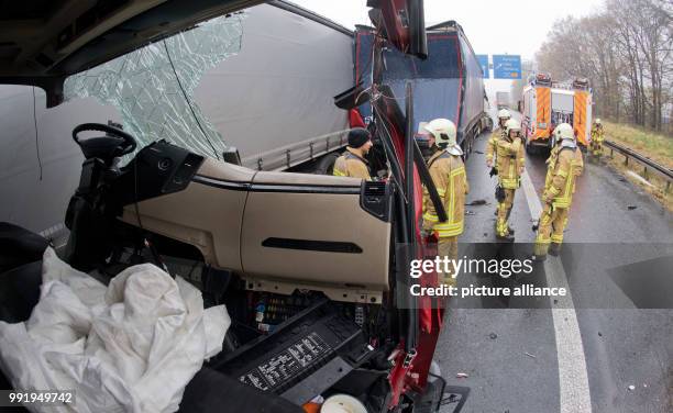 Firefighters stand on the motorway A2 after an accident at the motorway junction Hanover Buchholz, Germany, 21 November 2017. During an accident with...