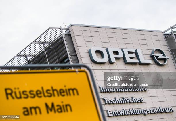 July 2018, Ruesselsheim, Germany: The town sign of "Ruesselsheim am Main" can be seen in front of the International technical development centre of...