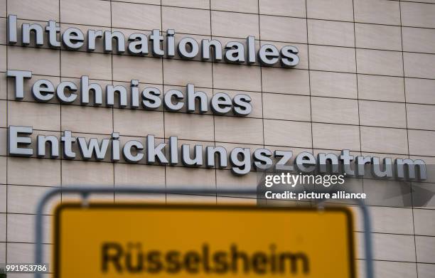 July 2018, Ruesselsheim, Germany: The town sign of "Ruesselsheim am Main" can be seen in front of the International technical development centre of...