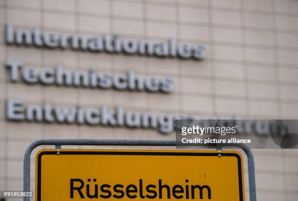 July 2018, Ruesselsheim, Germany: The town sign of "Ruesselsheim am Main" can be seen in front of the International technical development centre of...