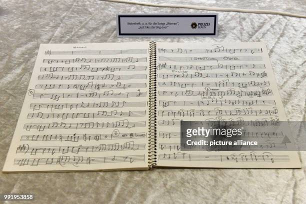 The police department of Berlin shows a stolen music book of Beatles musician John Lennon during a press conference in Berlin, Germany, 21 November...
