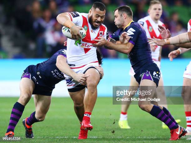 Leeson Ah Mau of the Dragons is tackled by Cameron Smith of the Storm during the round 17 NRL match between the Melbourne Storm and the St George...