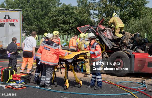 July 2018, Hannover, Germany: Firefighters release a driver from a completely demolished cab after an accident on the A2 motorway. On the...