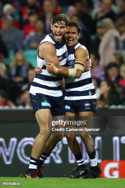 Tom Hawkins of the Cats celebrates kicking a goal with team mate Jamaine Jones of the Cats during the round 16 AFL match between the Sydney Swans and...