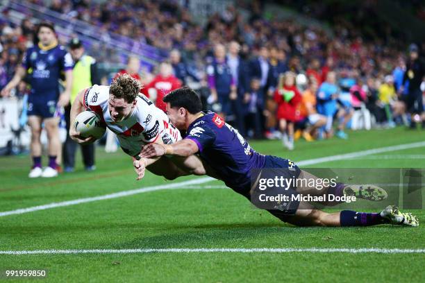 Kurt Mann of the Dragons scores a try past Jahrome Hughes of the Storm during the round 17 NRL match between the Melbourne Storm and the St George...
