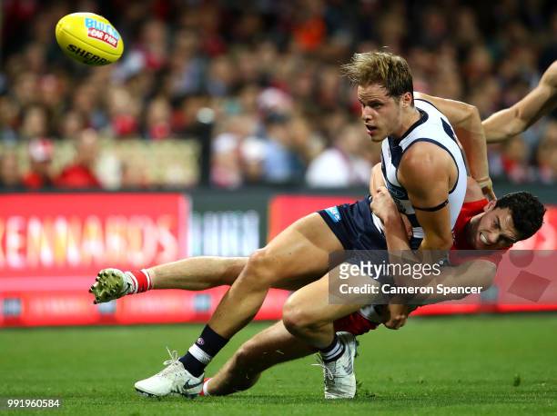 Jake Kolodjashnij of the Cats is tackled during the round 16 AFL match between the Sydney Swans and the Geelong Cats at Sydney Cricket Ground on July...