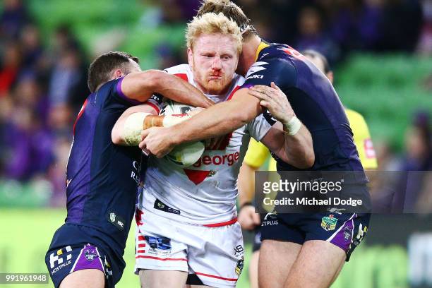 James Graham of the Dragons is tackled during the round 17 NRL match between the Melbourne Storm and the St George Illawarra Dragons at AAMI Park on...