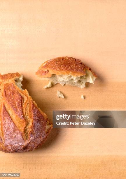 homemade bread on bread board - peter dazeley stock pictures, royalty-free photos & images