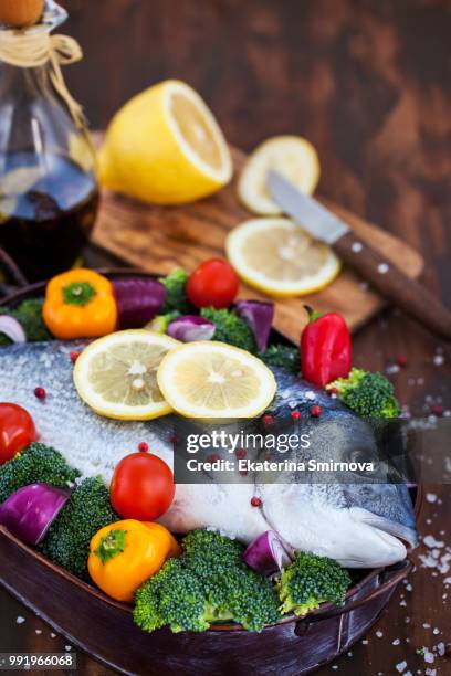 whole sea bream fish with vegetables - dolphin fish stock pictures, royalty-free photos & images