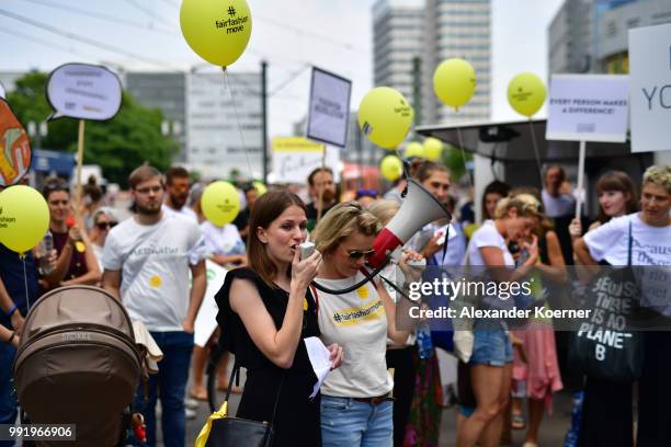 Workers of the fashion industry and protesters participate in the Greenshowroom Fair Fashion Move from Alexanderplatz to Kraftwerk Berlin on July 5,...