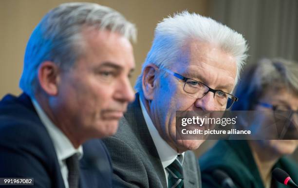 Green Party Minister-President of Baden-Wuerttemberg Winfried Kretschmann gestures as he speaks during a press conference regarding the the failure...