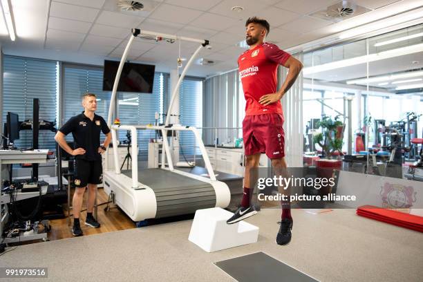 Dpatop - 5 July 2018, Leverkusen, Germany - Soccer Bundesliga performance diagnosis: Karim Bellarabi performs in a jump test. Photo: Marius Becker/dpa