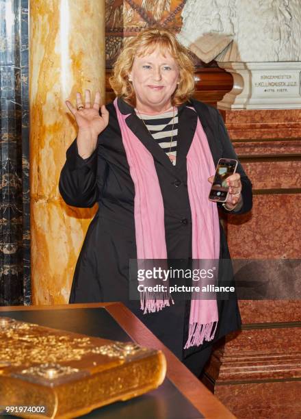 Maria Koehler, mother of Diane Kruger, takes a photo of the Golden Book with her phone at the city hall in Hamburg, Germany, 21 November 2017. The...