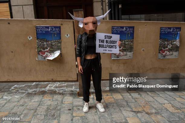 An animal rights activist poses for pictures as she holds a placard reading 'Stop the bloody bullfights' after a protest against bullfights ahead of...