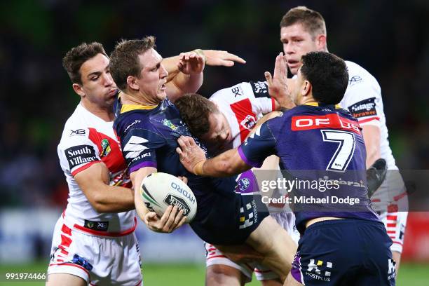 Ryan Hoffman of the Storm gets tackled during the round 17 NRL match between the Melbourne Storm and the St George Illawarra Dragons at AAMI Park on...