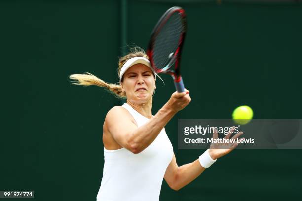 Eugenie Bouchard of Canada returns a shot to Ashleigh Barty of Australia during their Ladies' Singles second round match on day four of the Wimbledon...
