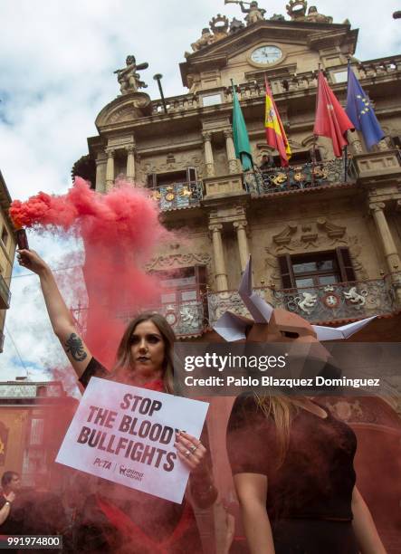 Animal rights activists protest against bullfights holding a placard reading 'Stop the bloody bullfights' ahead of San Fermin Running of the bulls at...