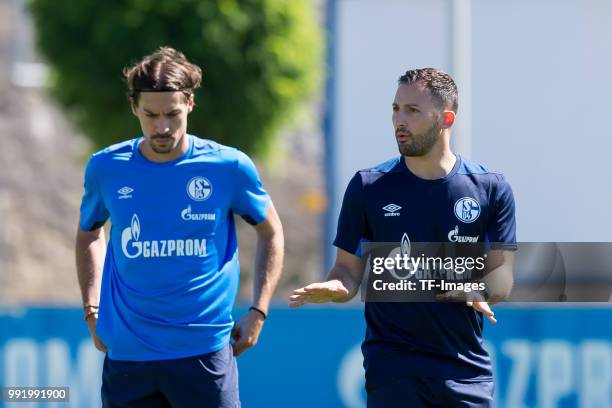 Benjamin Stambouli of Schalke and Head coach Domenico Tedesco of Schalke gesture during a training session at the FC Schalke 04 Training center on...