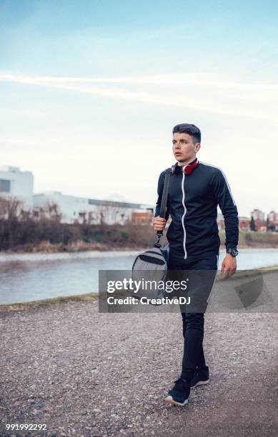 camminare sotto il sole - carrying sports bag foto e immagini stock